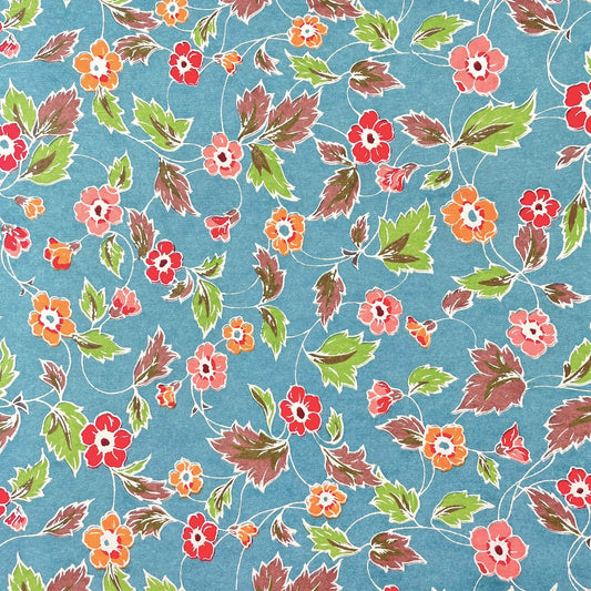 japanese stencil-dyed handmade paper with delicate repeat multi colour floral pattern on blue backdrop