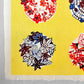 japanese stencil-dyed handmade paper with traditional botanical circles pattern on yellow backdrop