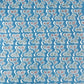 japanese stencil-dyed handmade paper with bonsai tree repeat pattern on blue backdrop