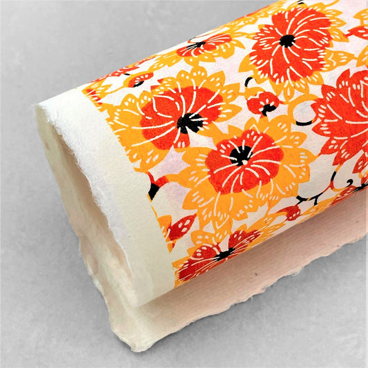 japanese stencil-dyed handmade paper with yellow and orange chrysanthemum repeat pattern
