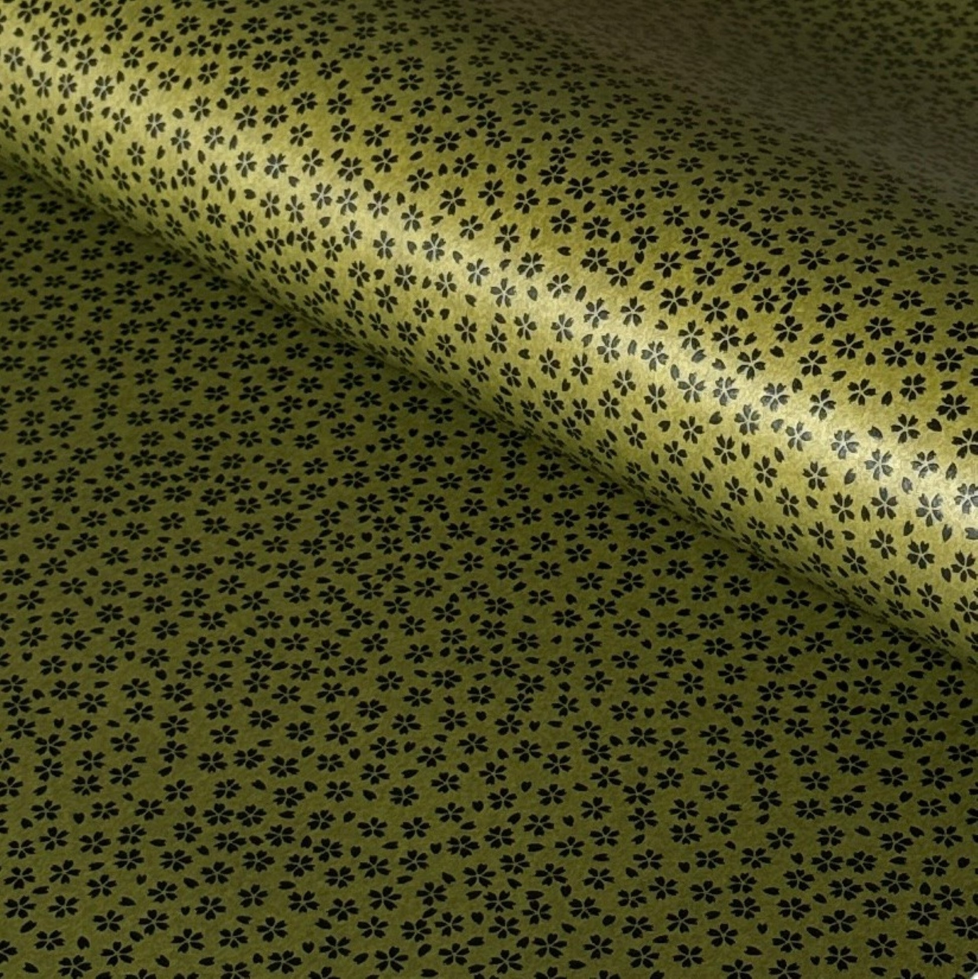 A sheet of Japanese lacquered yuzen paper in dark olive green with little cherry blossom flowers in black
