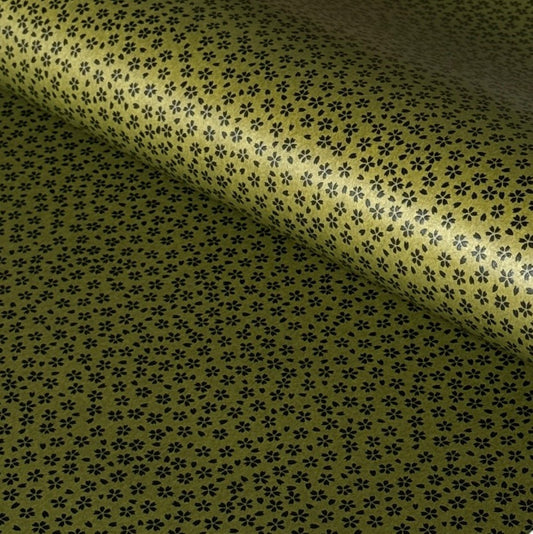 A sheet of Japanese lacquered yuzen paper in dark olive green with little cherry blossom flowers in black