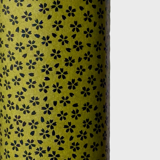 A sheet of Japanese lacquered yuzen paper in dark olive green with little cherry blossom flowers in black
