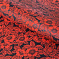A sheet of Japanese lacquered yuzen paper in black with a red camellia flower pattern