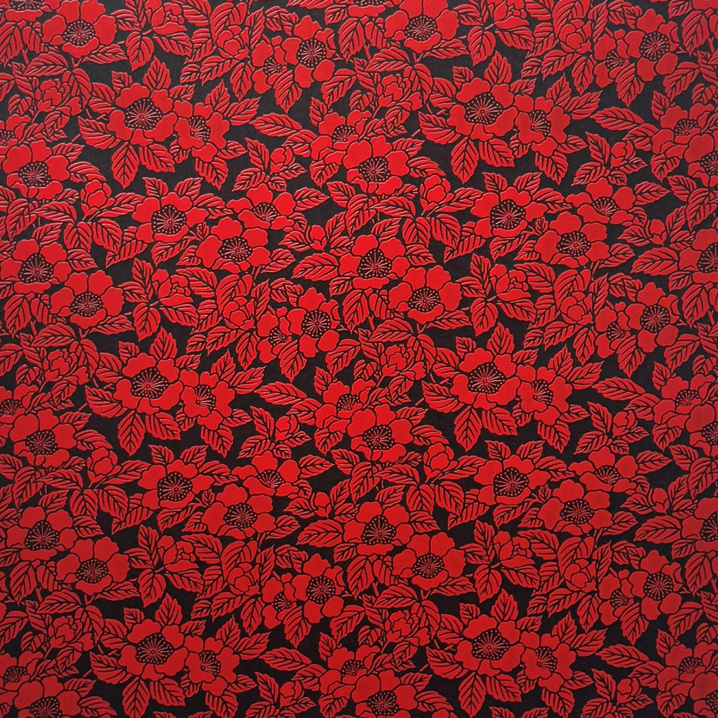 A sheet of Japanese lacquered yuzen paper in black with a red camellia flower pattern