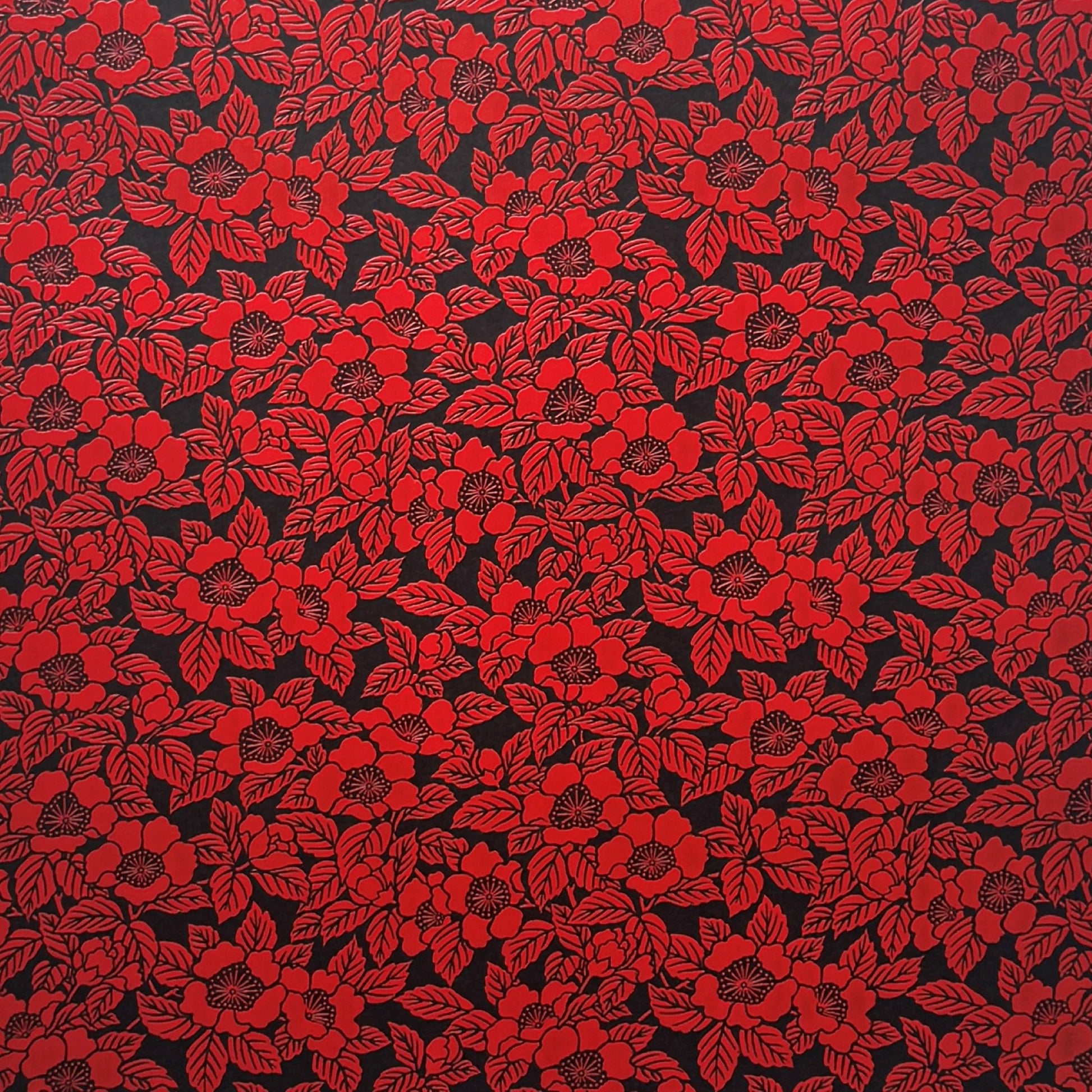 A sheet of Japanese lacquered yuzen paper in black with a red camellia flower pattern