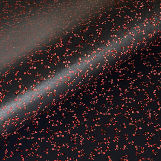 a sheet of Japanese lacquered yuzen paper with black background and little red dragonflies