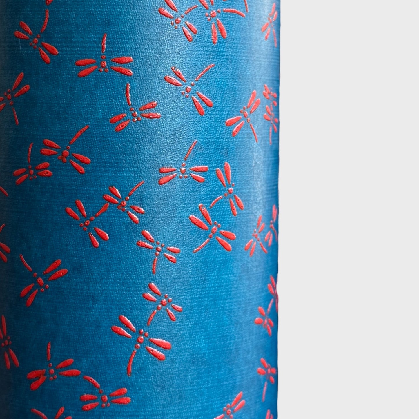 a sheet of Japanese lacquered yuzen paper with blue background and little red dragonflies