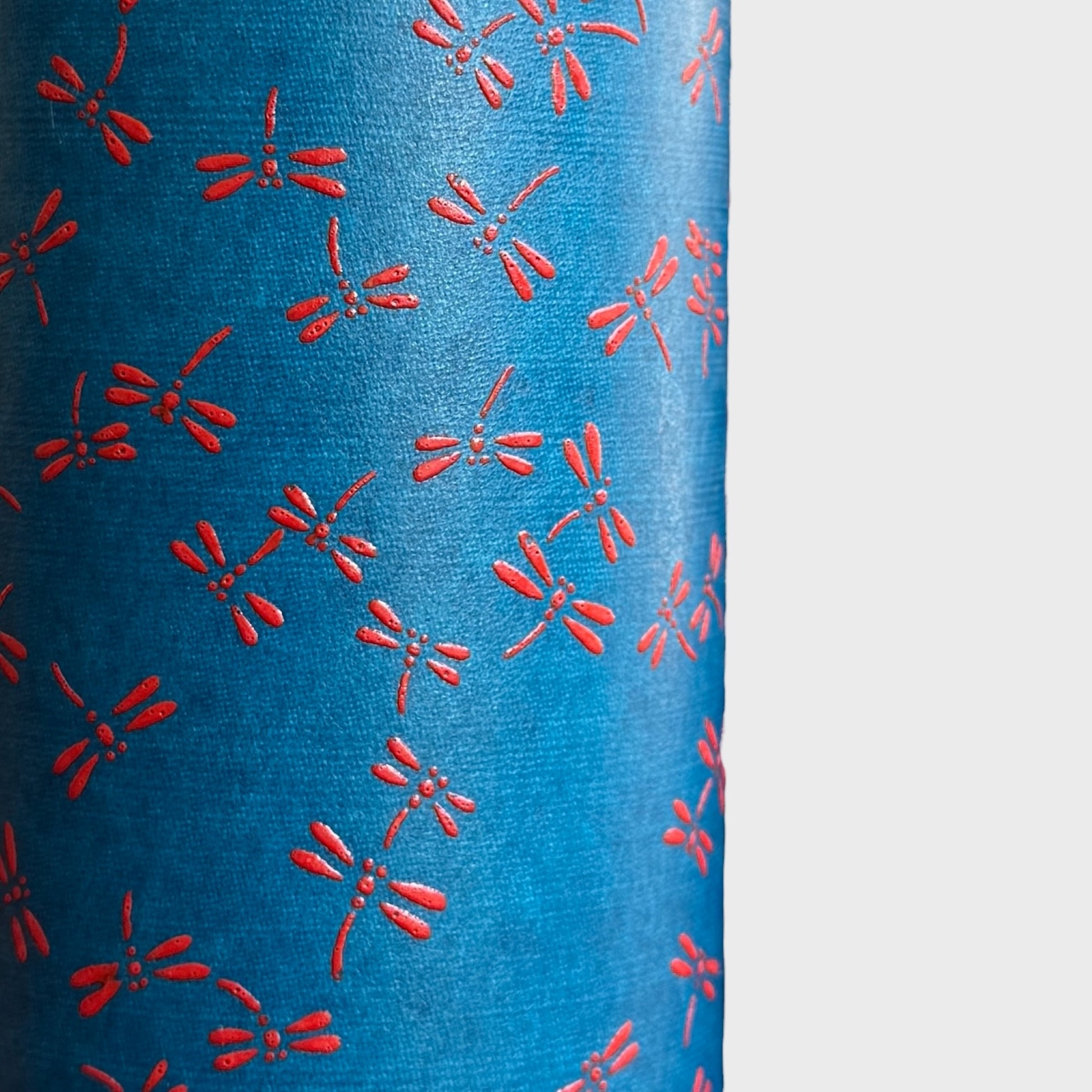 a sheet of Japanese lacquered yuzen paper with blue background and little red dragonflies