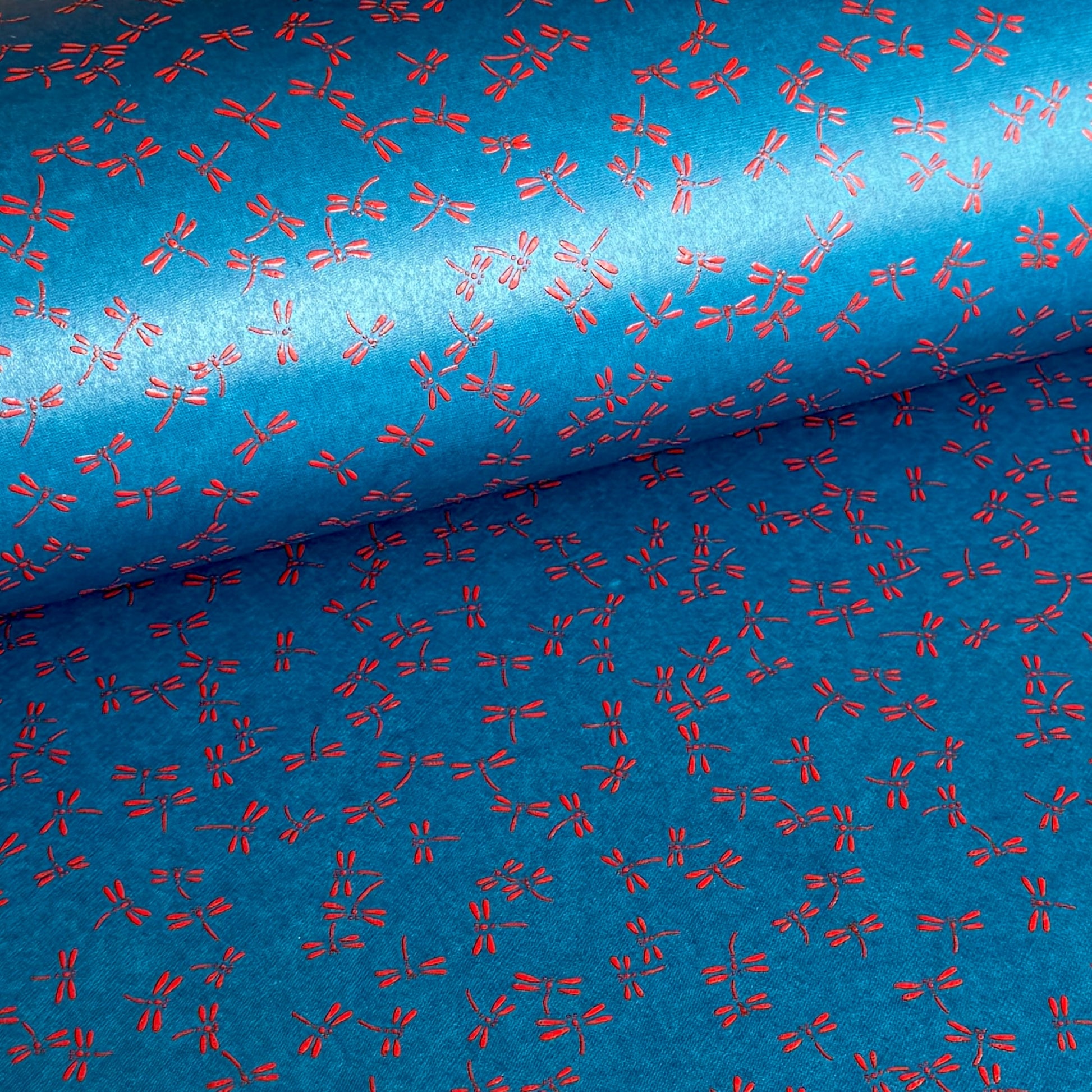 a sheet of Japanese lacquered yuzen paper with blue background and little red dragonflies