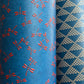 a sheet of Japanese lacquered yuzen paper with blue background and little red dragonflies
