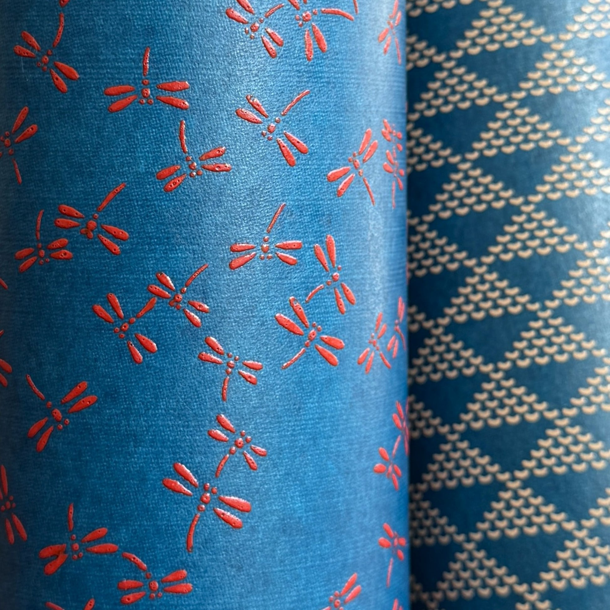 a sheet of Japanese lacquered yuzen paper with blue background and little red dragonflies