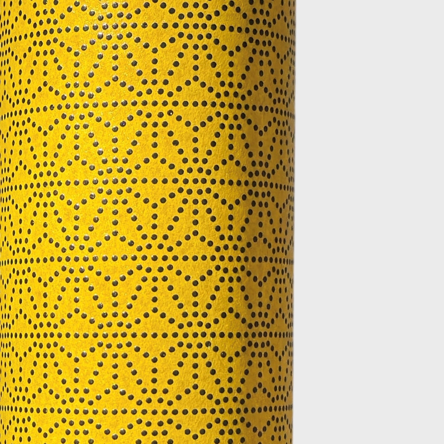 a sheet of Japanese lacquered yuzen paper with a mustard yellow background and a geometric dotted star pattern in black