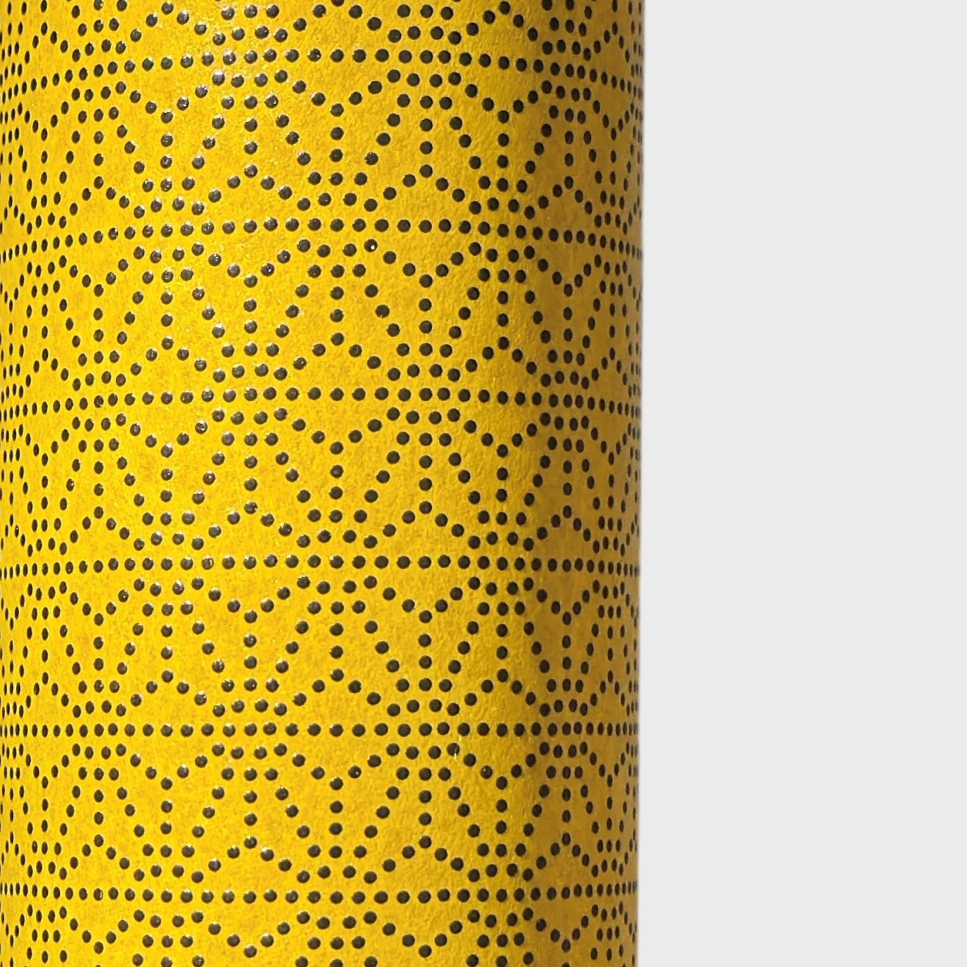a sheet of Japanese lacquered yuzen paper with a mustard yellow background and a geometric dotted star pattern in black