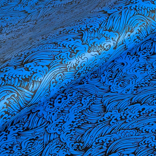 A sheet of Japanese lacquered yuzen paper in bright blue with a wave pattern in black