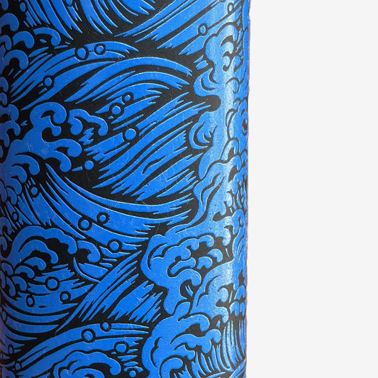 A sheet of Japanese lacquered yuzen paper in red with a repeat geometric flower pattern in cream