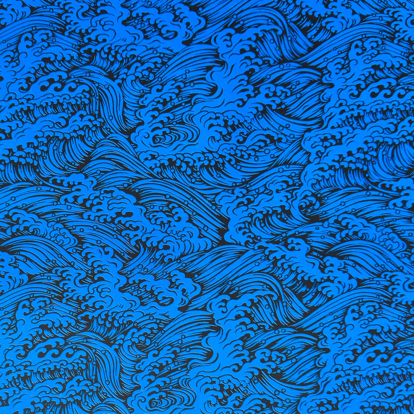 A sheet of Japanese lacquered yuzen paper in red with a repeat geometric flower pattern in cream