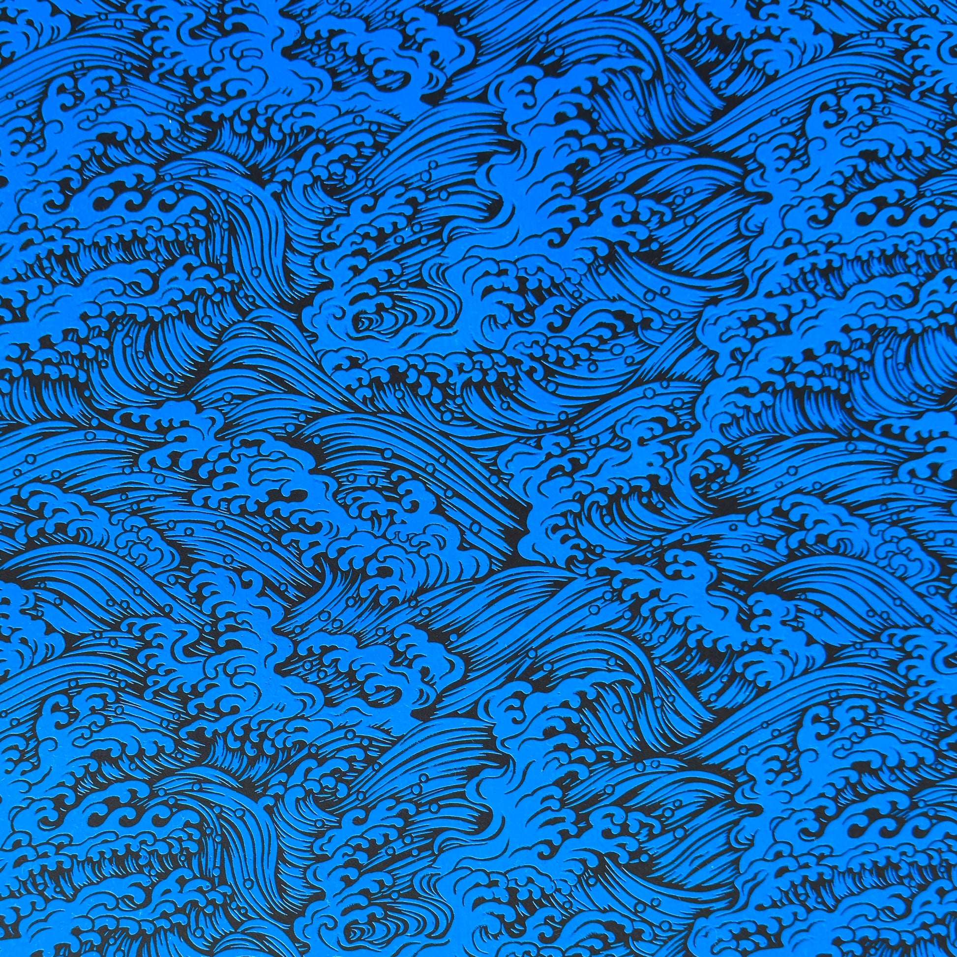 A sheet of Japanese lacquered yuzen paper in red with a repeat geometric flower pattern in cream