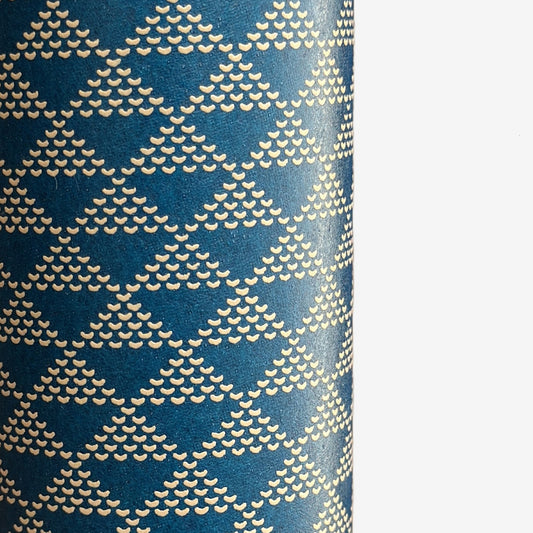 A sheet of Japanese lacquered yuzen paper in deep teal with a repeat small triangle geometric pattern in cream