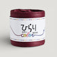 a reel of Japanese paper string in wine colour