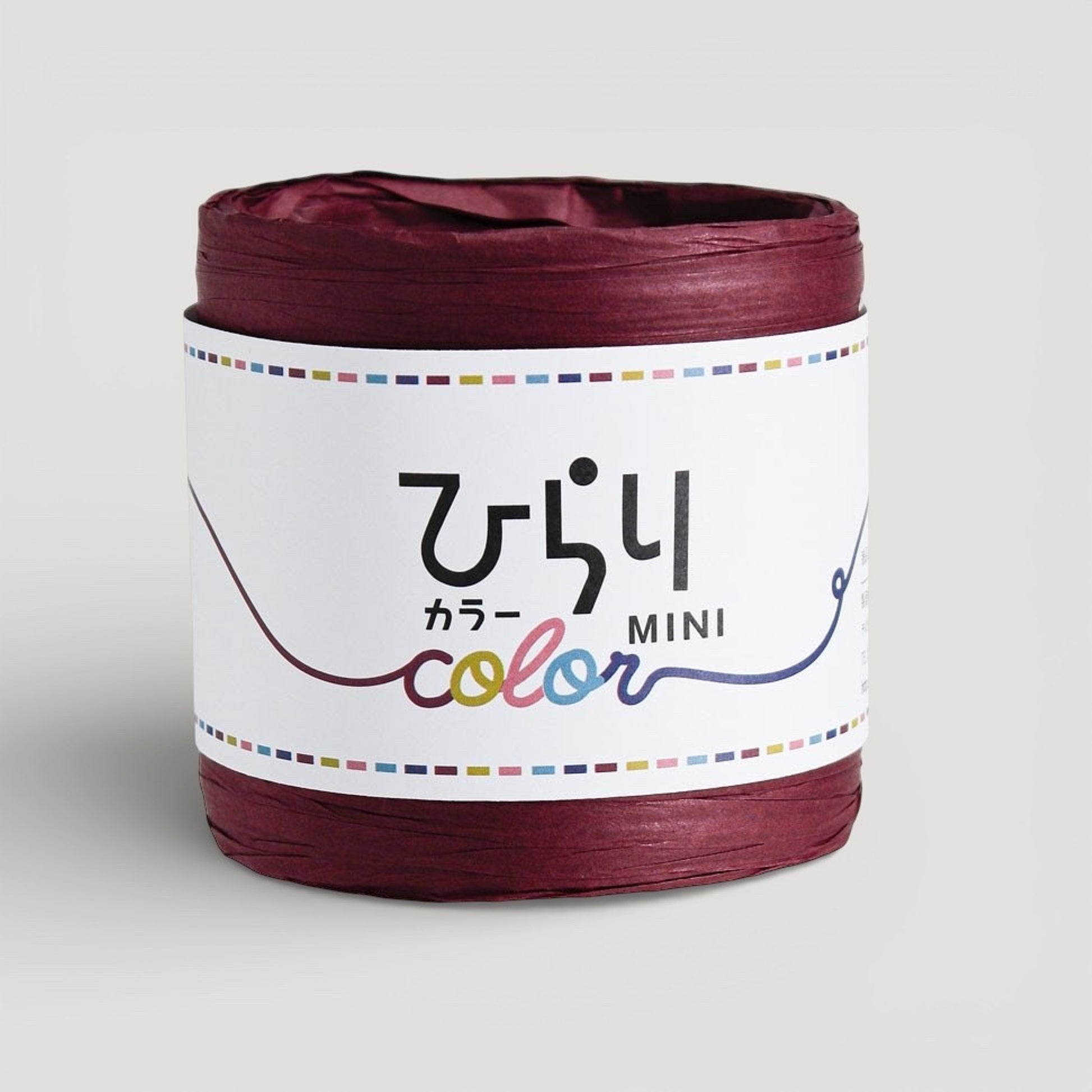 a reel of Japanese paper string in wine colour