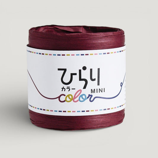 a reel of Japanese paper string in wine colour