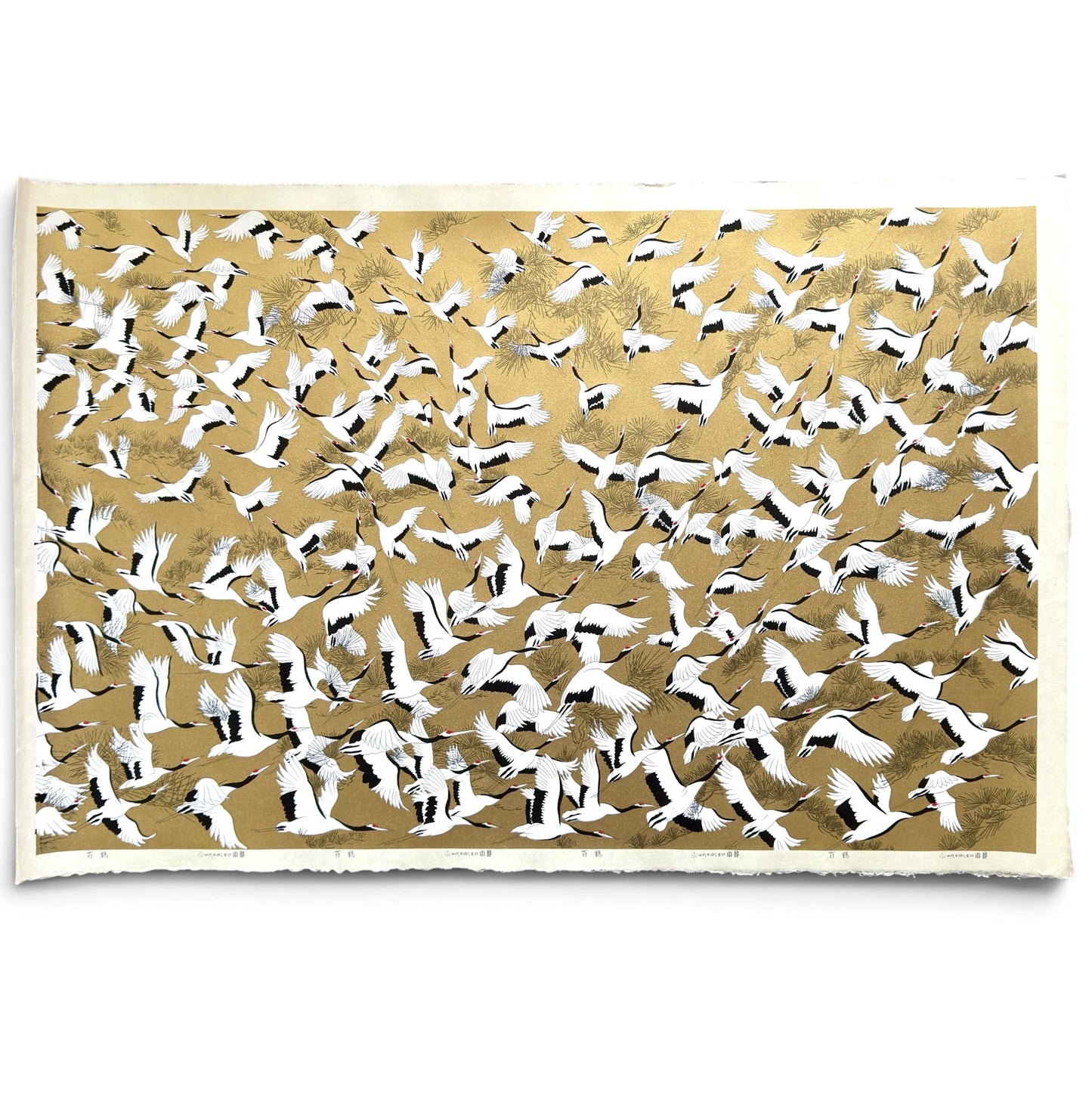 a sheet of Japanese Sogara yuzen paper with an image of white and black flying cranes on a gold background.
