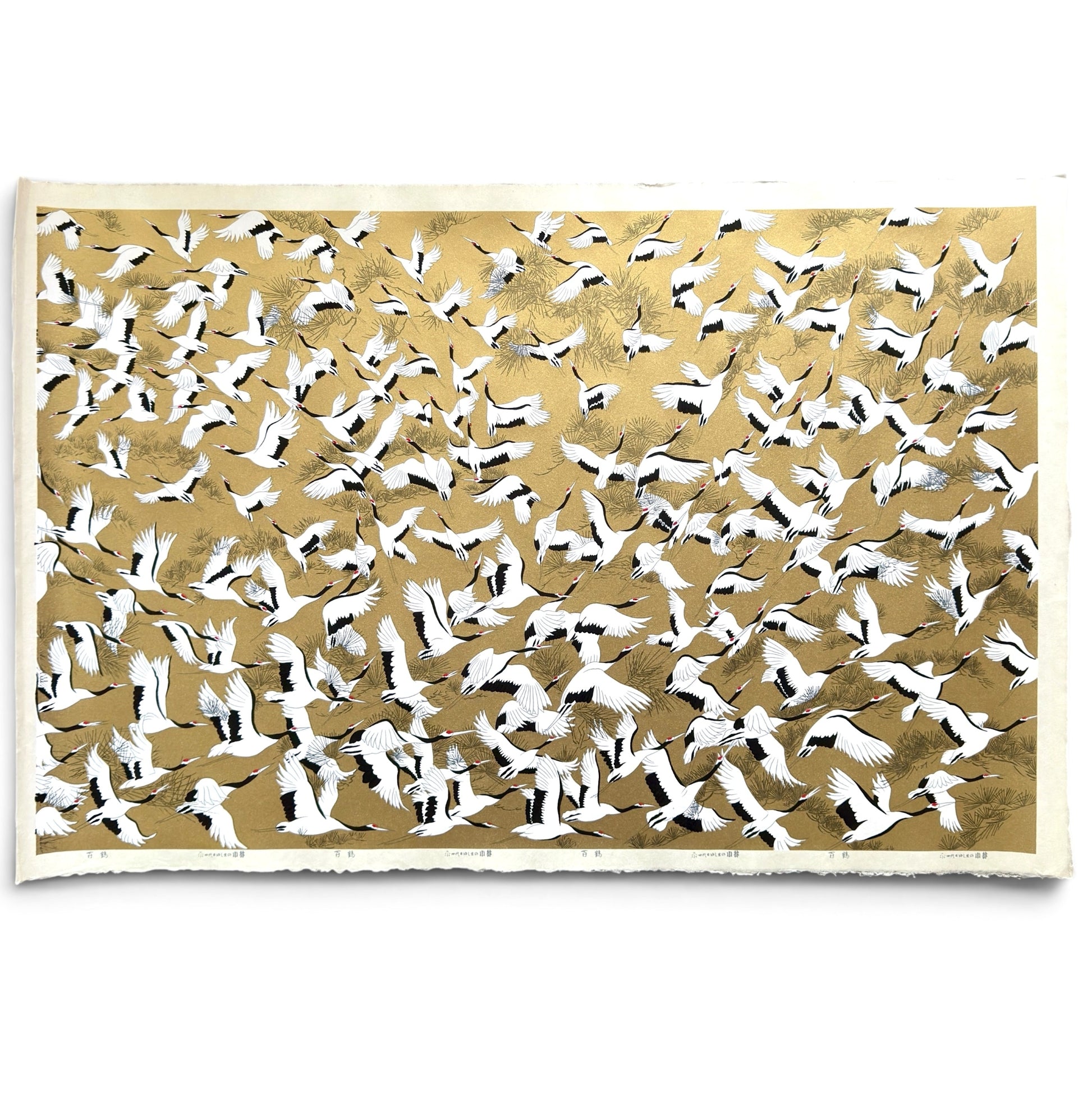 a sheet of Japanese Sogara yuzen paper with an image of white and black flying cranes on a gold background.