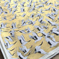 a sheet of Japanese Sogara yuzen paper with an image of white and black flying cranes on a gold background.