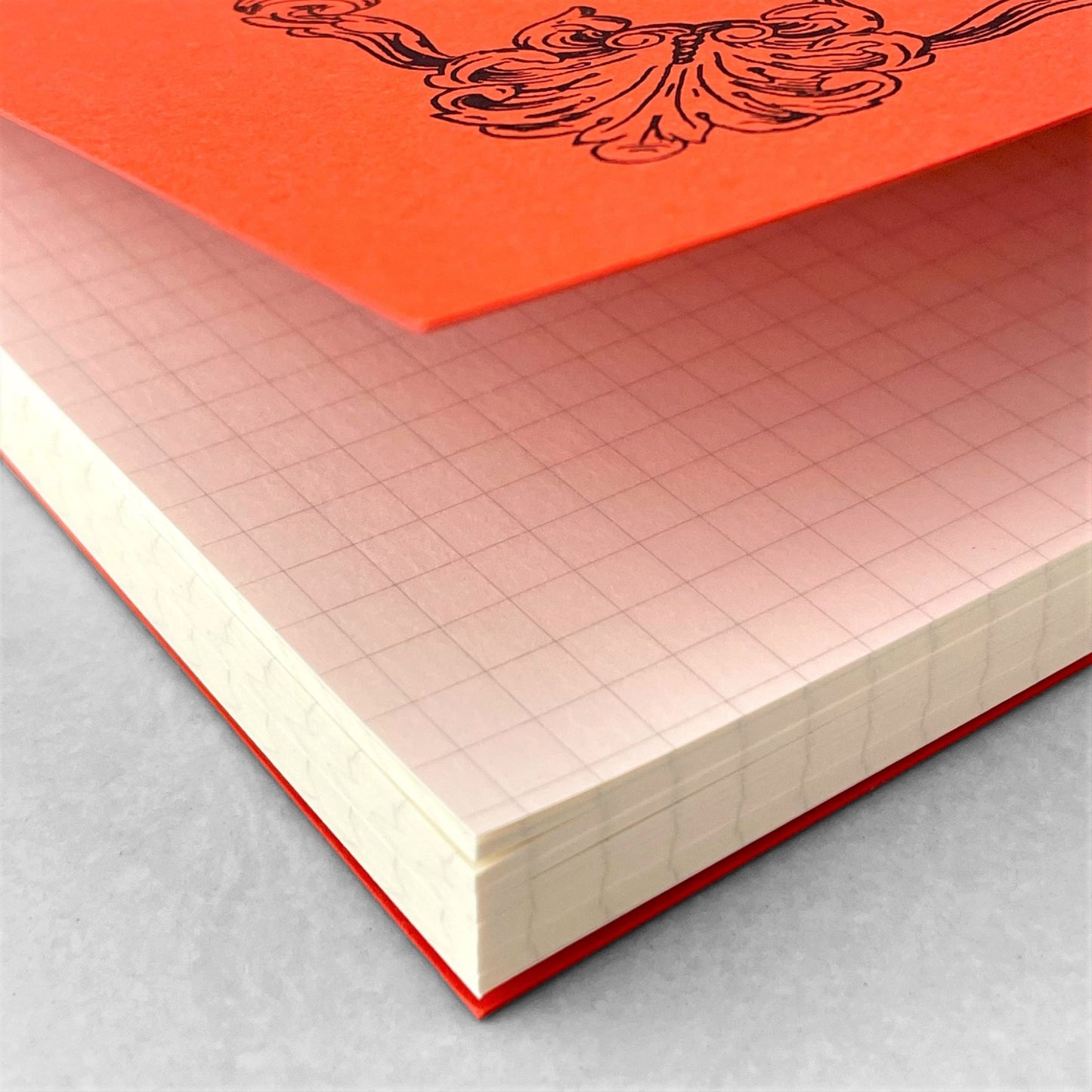 Softcover notebook with grid pages. The cover is plain red with a decorative black border and branding. Life Noble range by Japanese brand Life
