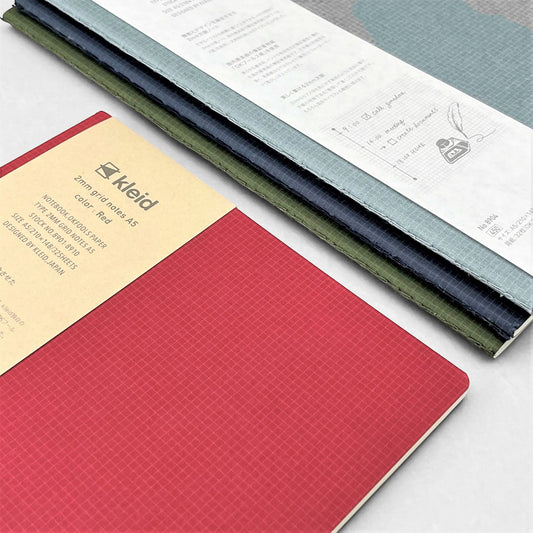 A5 soft cover notebook, cover is red with a small white grid pattern by Japanese brand Kleid