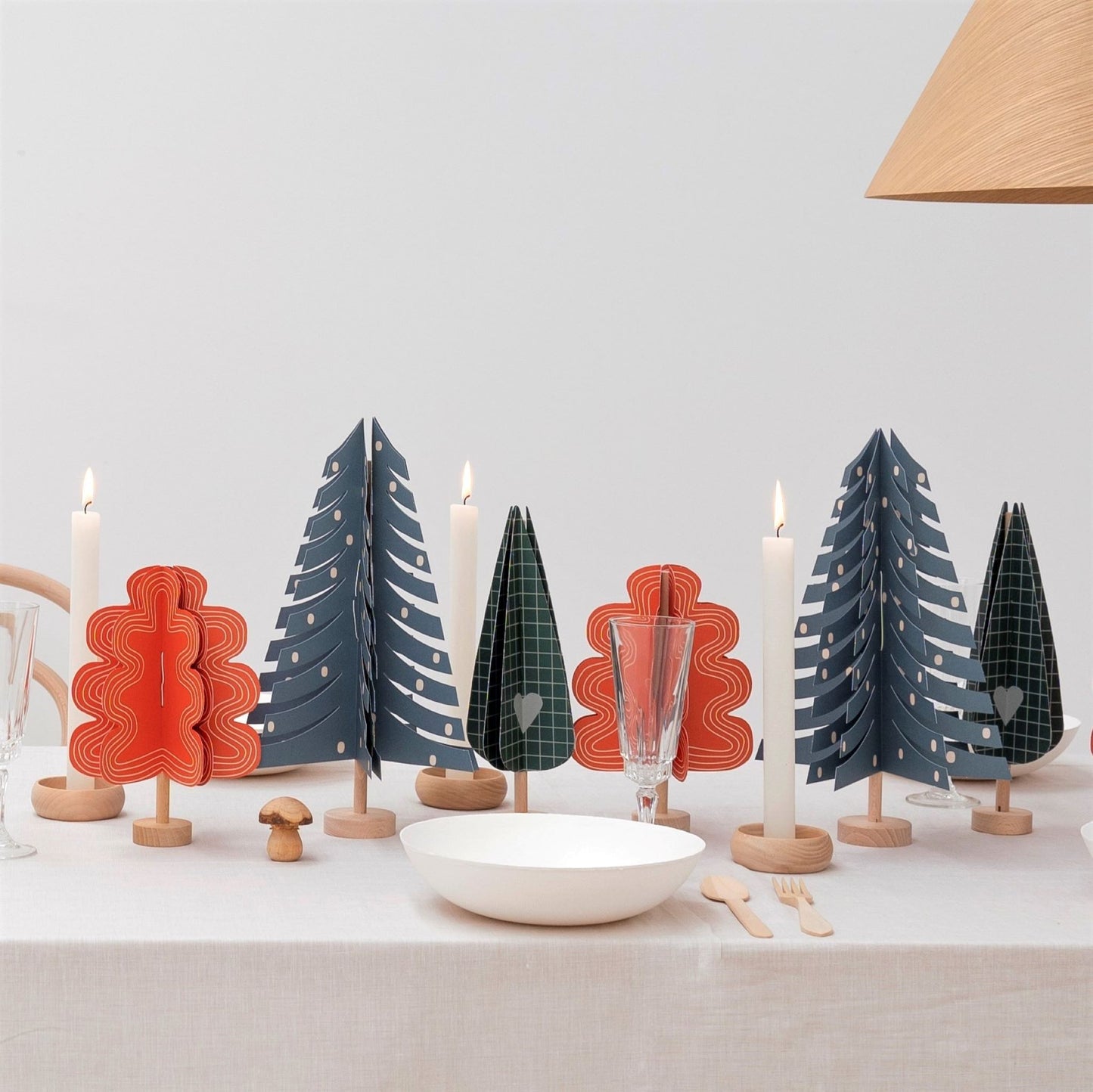 a red oak tree paper craft kit by Jurianne Matter, pictured with a group of paper trees on a table