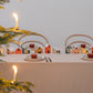 set of 12 colourful paper houses by Jurianne Matter, pictured as a centre-piece on a dining table