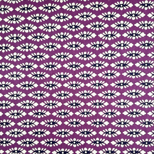 japanese katazome-shi paper (stencil-dyed) with a white and black repeat pattern on purple.