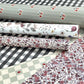 rolls of wrapping paper by designer Katie Leamon in botanical floral patterns , checks and stripes