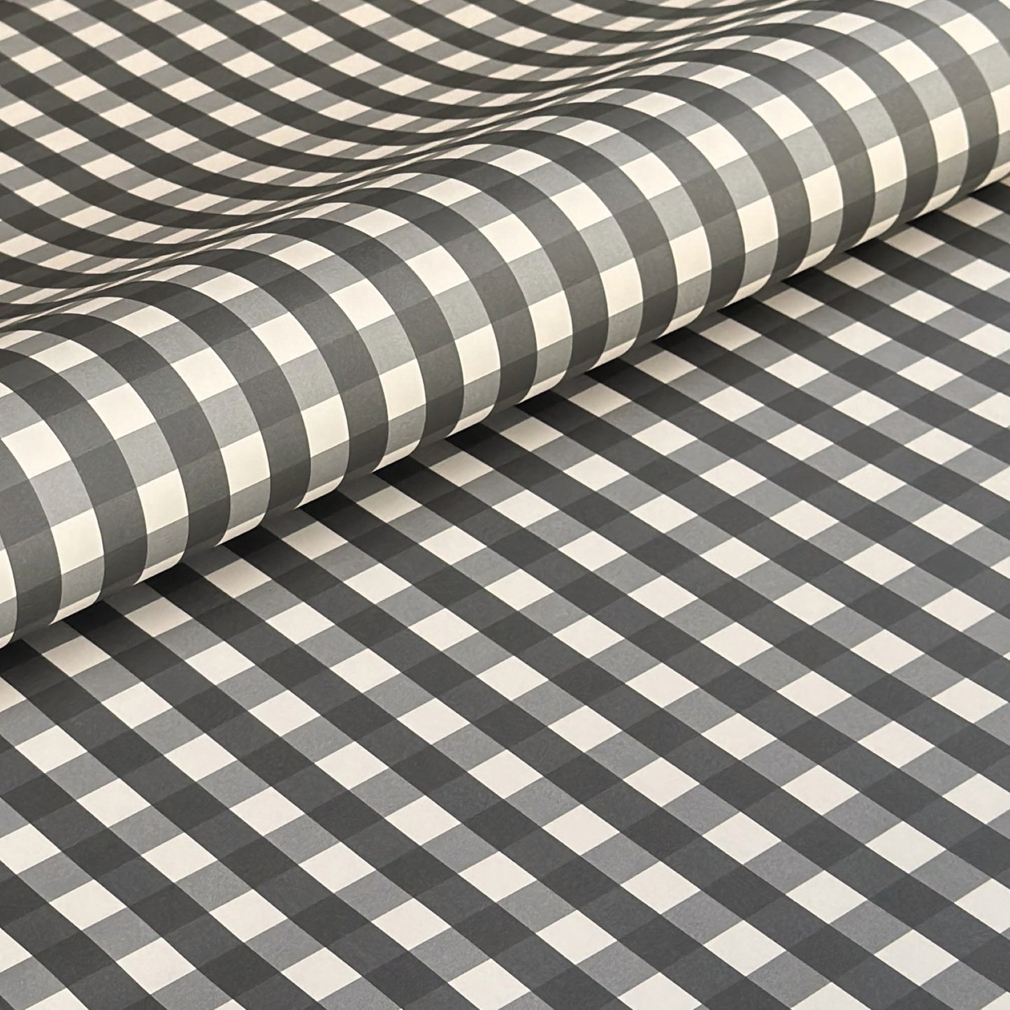 a sheet of wrapping paper with a black and white gingham pattern