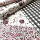 a sheet of wrapping paper with a black and white gingham pattern. Pictured with a floral pattern