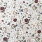 a sheet of wrapping paper with a pretty floral design of pressed flowers on a white background
