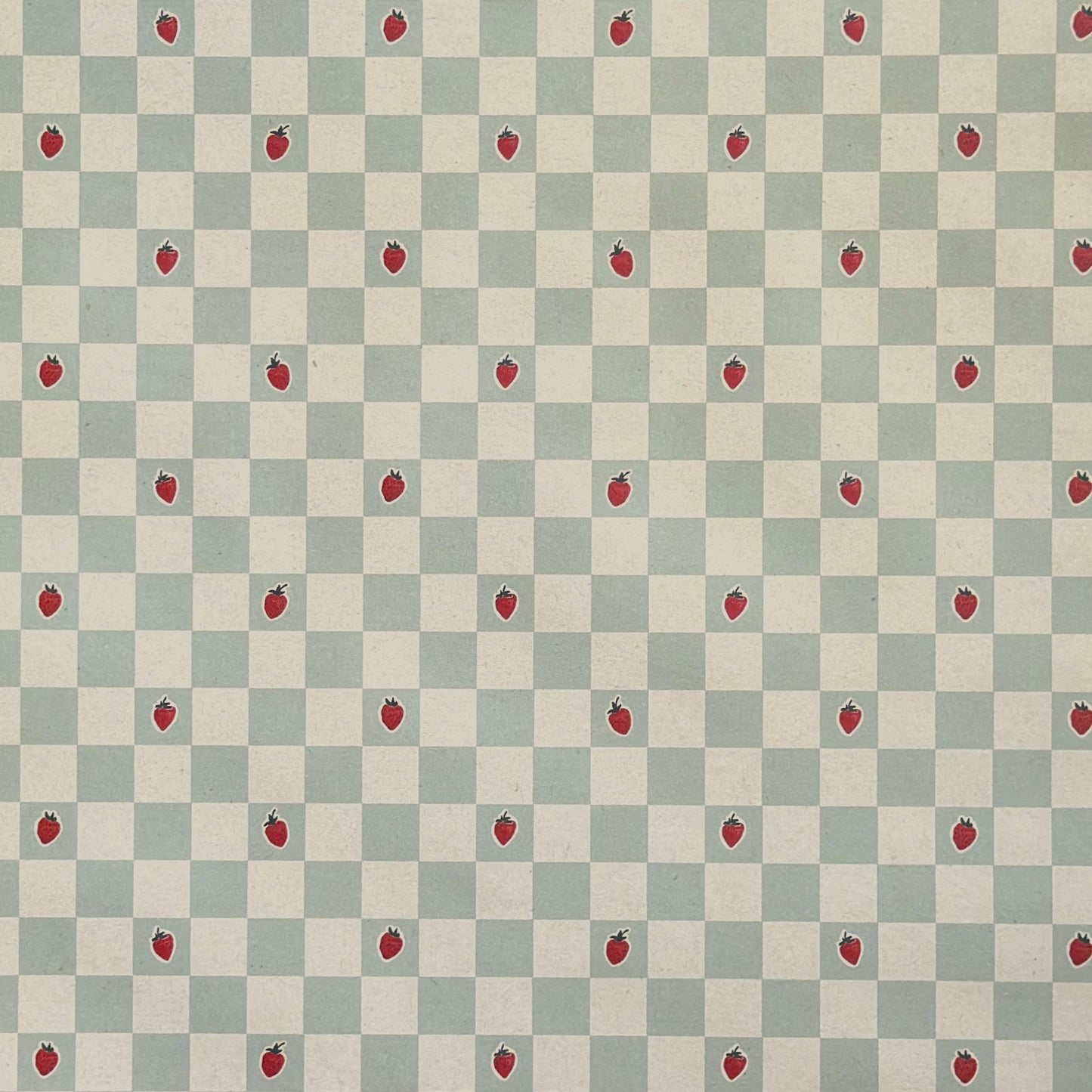 a sheet of wrapping paper with a soft green and cream checkered pattern with vintage style strawberries