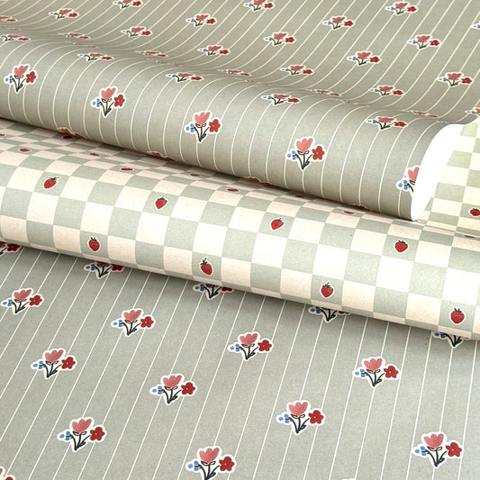 a sheet of wrapping paper with a soft grey-green stripe and pink and red vintage floral flowers. Pictures with a chequered paper from the same collection