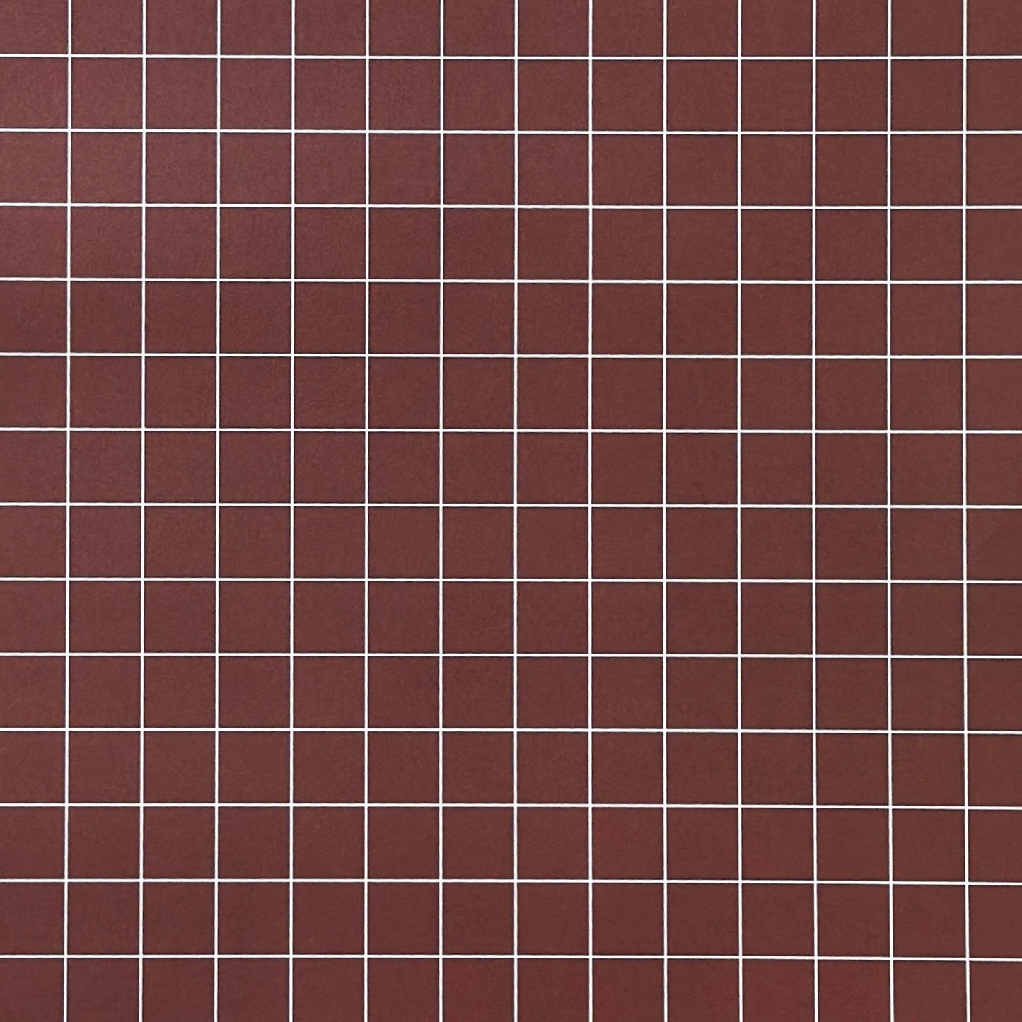 a sheet of wrapping paper in brown with a simple white grid pattern