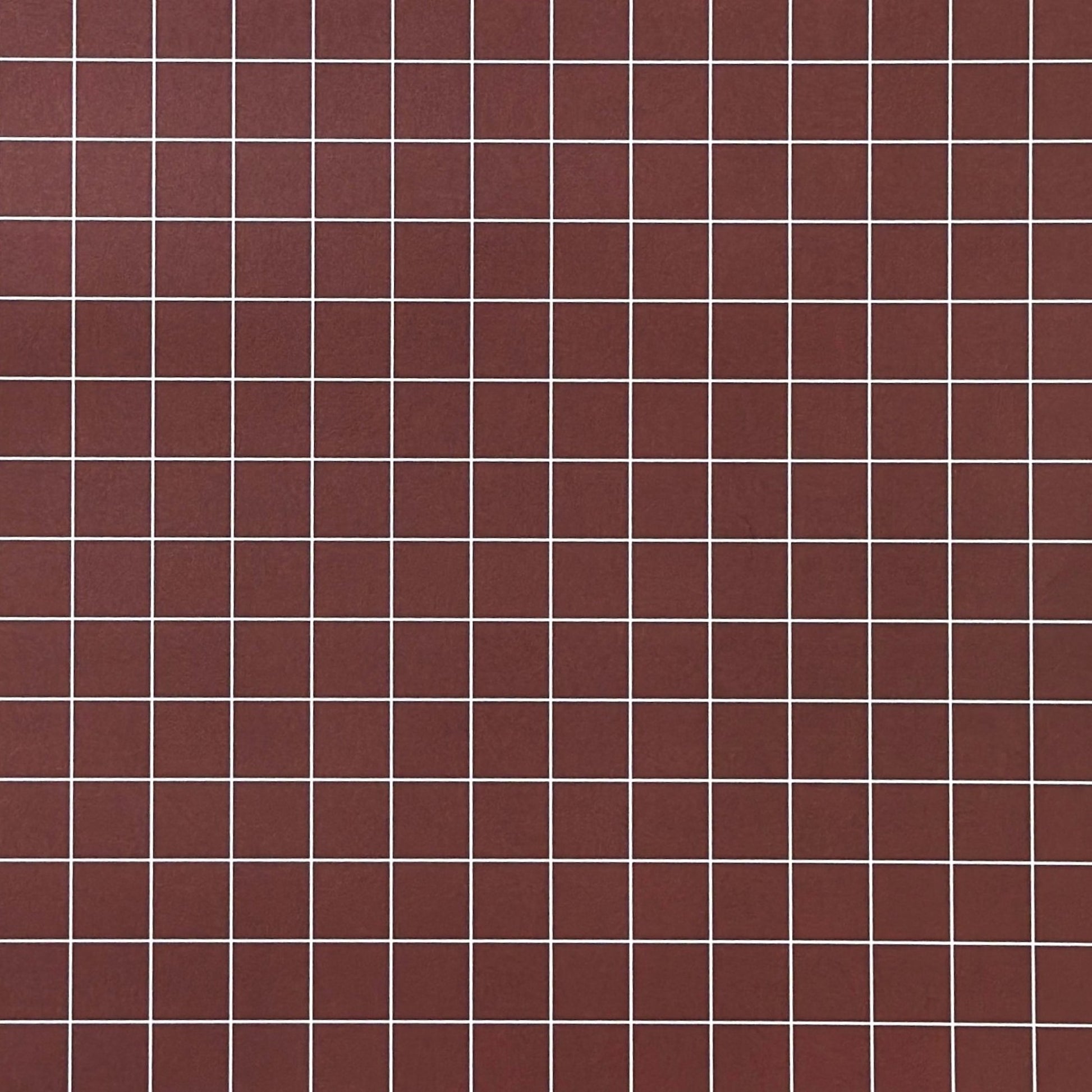 a sheet of wrapping paper in brown with a simple white grid pattern