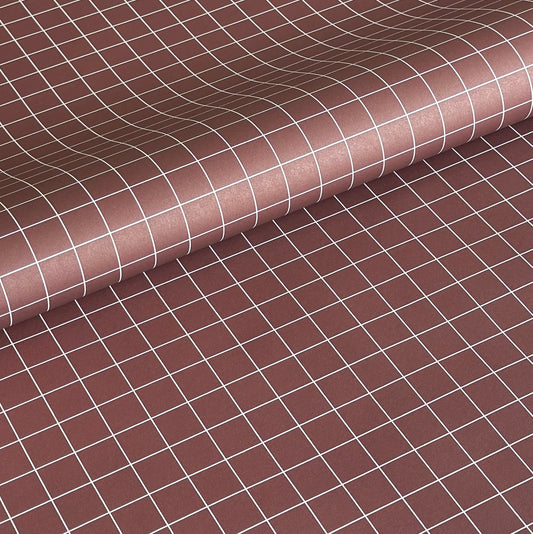 a sheet of wrapping paper in brown with a simple white grid pattern