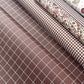a sheet of wrapping paper in brown with a simple white grid pattern