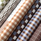 rolls of geometric wrapping papers in neurtral tones