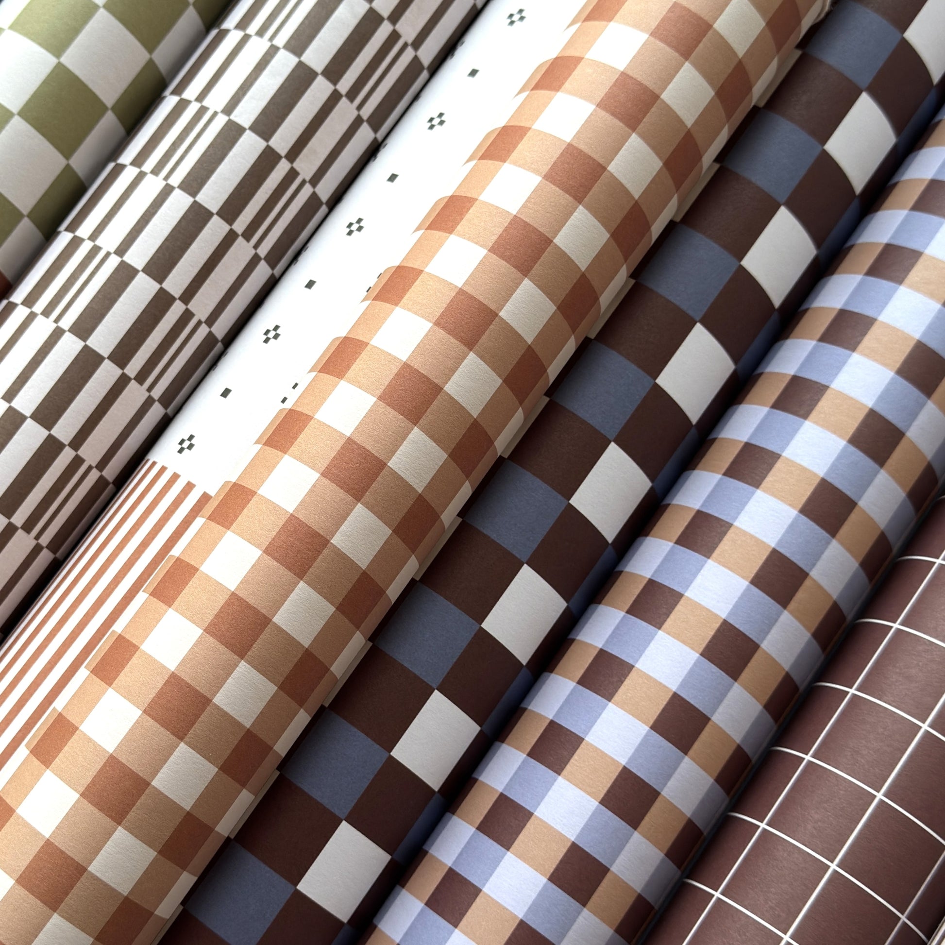 rolls of geometric wrapping papers in neurtral tones