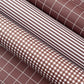 a sheet of wrapping paper with a small scale gingham pattern in russet brown