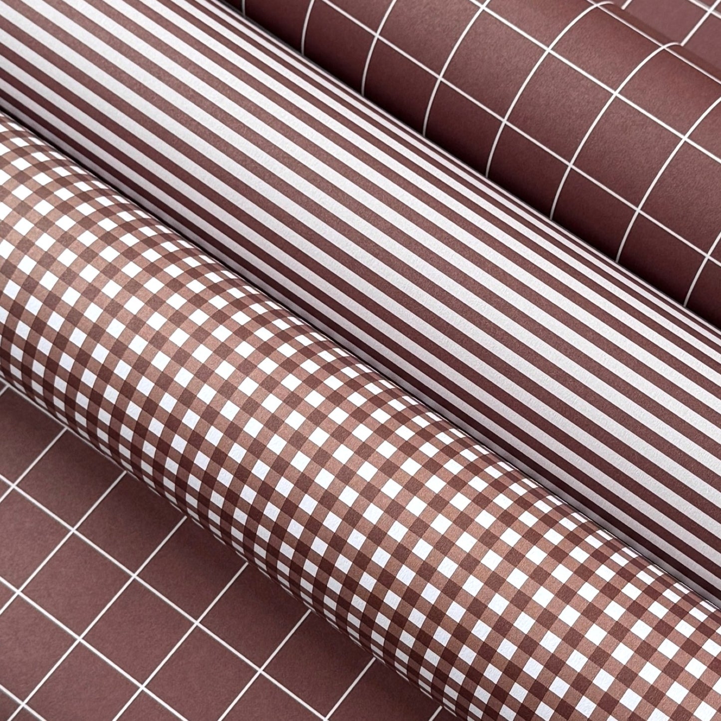 a sheet of wrapping paper with a narrow stripe design in dark brown and cream