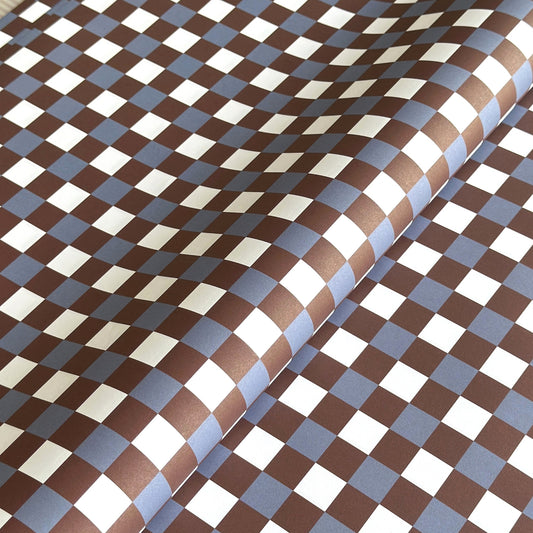 a sheet of checkered wrapping paper in brown, blue and white