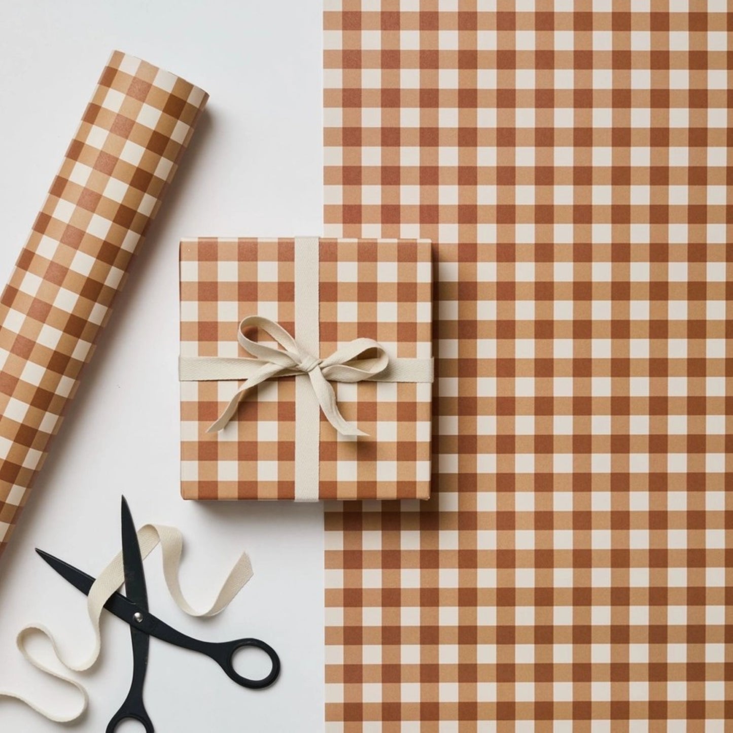 a sheet of wrapping paper with a cinnamon brown gingham pattern